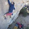 Pulling (if you can call it that) through the crux. Amazing problem. Credit to Mike Brady for the photo.