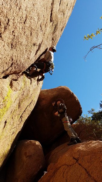 Pete Tagala working out the difficult start of Orange Crack. Mike Knarzer watches. 