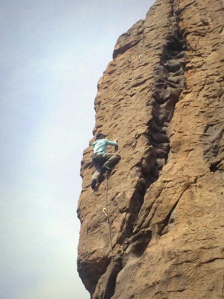 Mid-way up the face on the FA, crux is at the small overhang above.