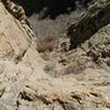 Looking down at where the route starts. It is "right around the corner" East from Hummingbird Saddle. Go through some bushes to a flatter ledge to get climbing shoes on. 