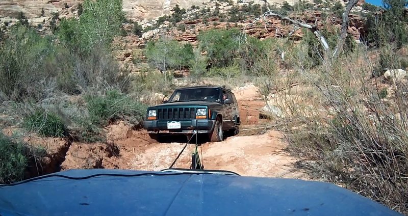 Attempting to winch Jeep completely high centered in ruts