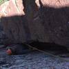 Crawling out of the final roof of the Maw. Matt Johnson belaying and photo.