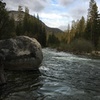 The Jumping Rock Boulder during heavy flow, with Wawona Dome visible through the trees upstream.