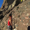 A climber taking a direct variation to the start, with the first piece of pro visible. I placed gear in a similar spot but found the climbing easier and better protected doing the undercling to traverse left.