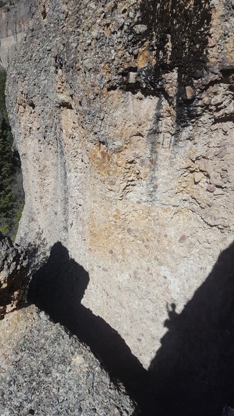 4 Star 12a as seen from part way up Lucy's Perch.  The anchors can be seen in the orange rock at about 2/3 height.  The anchors for Den Mother can be seen just to the right and below the wet/moss streak.