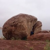 Shot of the boulder and the lake right behind it.