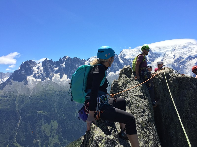 Sitting on the summit with our guide Jon Bracey waiting in queue to drop down.