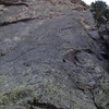 Beta shot of Direct 5.10a bolted start to Left Center. The climber shown is at the belay, and there are now 2 bolts/rap rings at the belay.