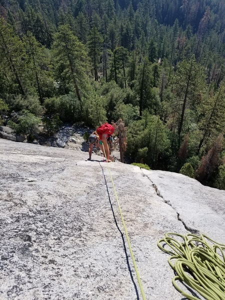 Climber nearing top of Pitch 2.