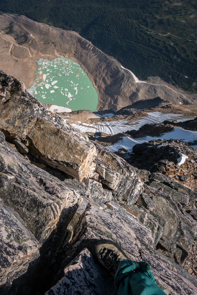 Solo at the top of the 5th class section with a view 3000' down the north face to Cavell Pond