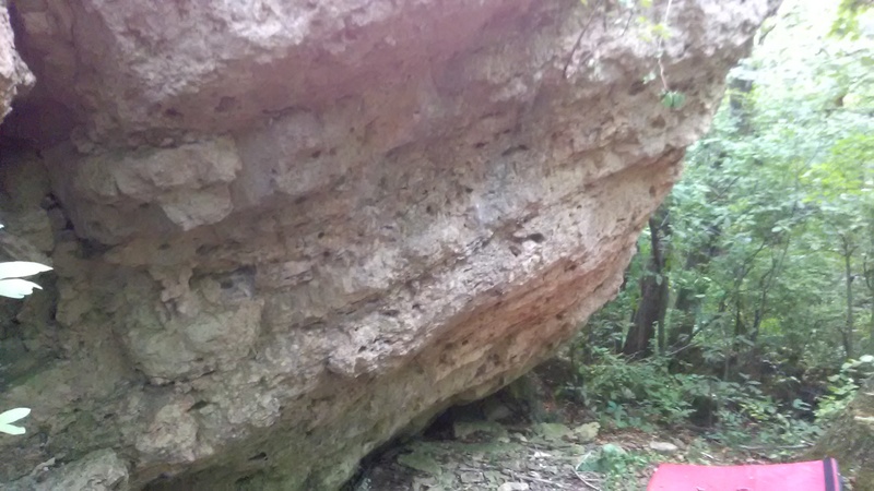 The Pelo del Perro boulder's east side contains some of the best quality sandstone at The M. The west is also overhung, while north and south sides are more vertical.