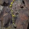 Great Route! Start left of the boulders, clip the low bolt then gain a ledge. Climb up to the second bolt and traverse left to the arete. Climb the arete using the occasional pocket, and a few ledge-y jugs.