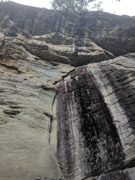 Start up the thin finger crack to the ledge than move past the large flake and clip the perma.  From here the route switches gears and it is a jug haul to the chains.