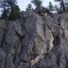 Heading up the exposed third pitch arete, taken from across the canyon.