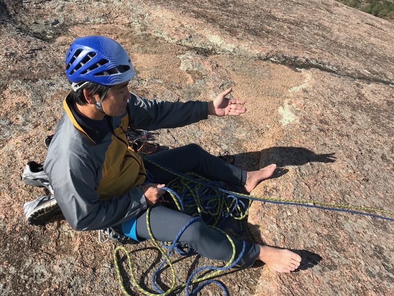 Oka demonstrating the body belay on the FA of the Meat Sweat route.