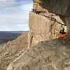 Coming around the bend on the Great Roof pitch.  Phenomenal belay ledge, incredible position. All smiles for the last 2 pitches on this classic!<br>
<br>
Photo by TK