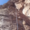 Top roping Sunny Side Up.  Route follows up left under the big bulge.