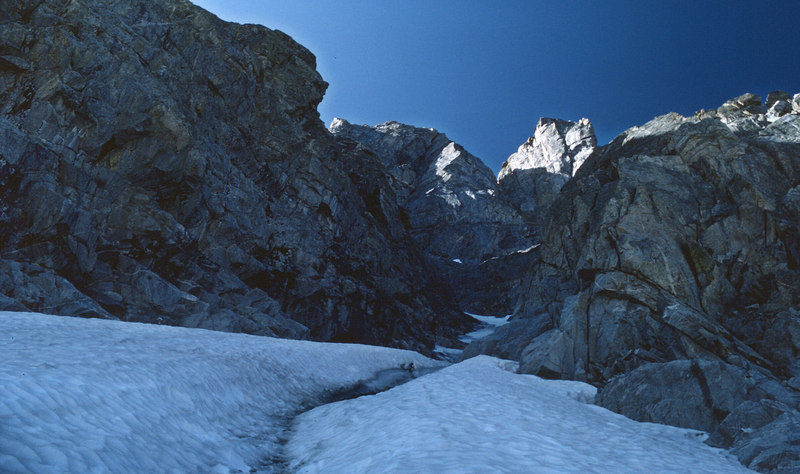 Looking up the gully. The chimneys are left of center while Cutthroat Spire is in the sun to the right.