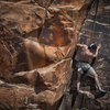 After a sequence up the blocky arete and a wide dropped knee move, a horizontal split to recover.