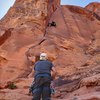 Josh Noe laybacking the first section of the crack while James Schaefer belays.