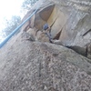 Doug throwing the bouldering pad off the ledge