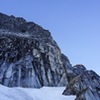 Looking up at the base of the climb. You can see footprints leading to the moat crossing and start of gully scramble/p1