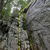 The whole first pitch.  Climb up blocky terrain to a big ledge and tree, traverse right, then head up the weakness to a tree directly above the start.