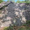 'Fish in a Barrel' goes left-to-right, starting just at the edge of the brush, and follows a shallow crack up to the top.