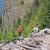 Bill and Shaun Coe on the slash pile looking at the cliff in 2010 after climbing. Photo: Haydar Kutuk