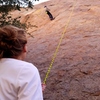 Teaching a new climber the ropes on western facing slab climb at Point of Rocks