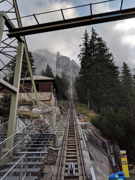 Base of the funicular. Approach goes around the left of the first tower. Descent comes down the funicular's steps.