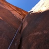 Just above the first chimney on pitch 2, looking up the wide hands