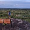 All routes are over the edge; only some can be reached from the top. Climber is standing at the rappel carabiner.