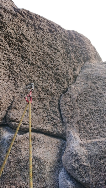 2nd to last bolt which protects the perplexing moves through the overhanging head wall.