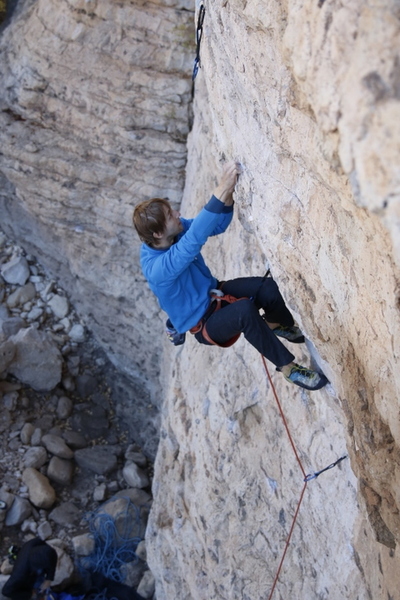 Eyeing the crux move...
<br>
Photo by Eric Andersen