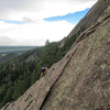 A climber on Freeway Ridge about 100 feet below the jump. The rock where the climber is is less steep and has a bit more texture.