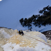 Marielle follows Devin Farkas and I up the route on March 9, 2019. I'm perched below the upper curtain to photograph.