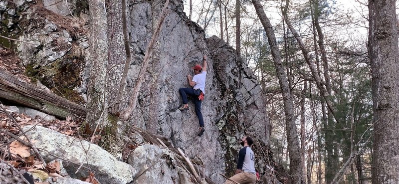 I believe this might be the FA on this boulder.  The rock definitely needs more cleaning but we were able to clean enough to ascend the face up the middle.