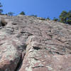 This is the view seen after climbing from the northern gully up onto the east face. Holds range from very positive jugs to pebbles and fingertip holds, with some avoidable smooth areas. There are 3 small troughs that are fairly easy to overcome.