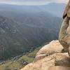 A pair of anchor bolts is visible on the brink, on the right, under and left of the boulder that I referred to in my February 27 comment.