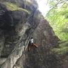 Zach using a welcome foothold on the very steep hand crack