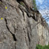 Starts left of pic, then continues climbers right to a large pocket and the chains.