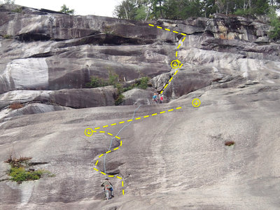 Route Photo - Climbers are rapping from the top of the arch on STANDARD/DIRECT to the first belay 250 ft up the slab.  The route is actually straighter than it appears in this photo.