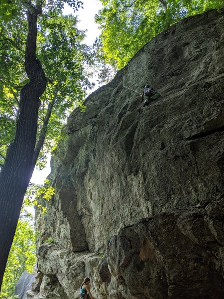 Dan at the step across of faith before the 6th bolt.  Way steeper at that point that the picture implies.   The woman below is on Machine Head.