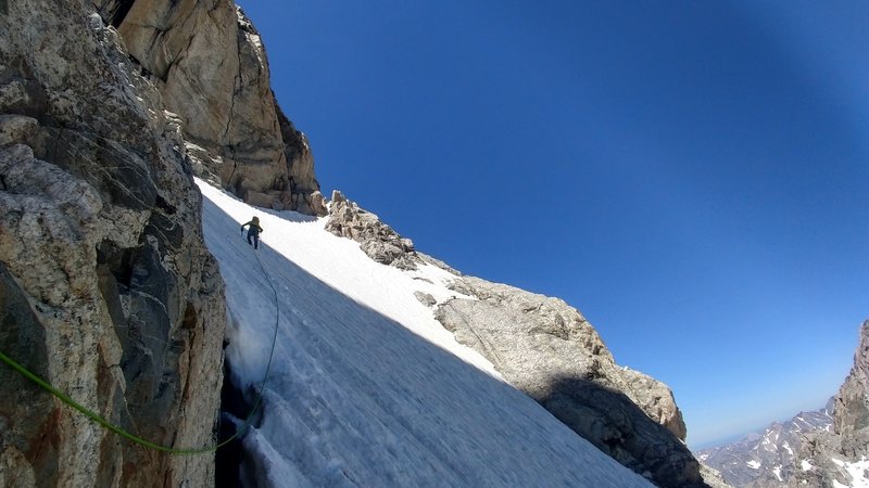 Heading across the snowfield on the first ledge.