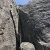 Start of route - 5.7 Crack/Flared Chimney with Flake to the Left above Boulder