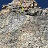 My climbing partner, Jason, at the end of the third pitch. We traversed left from the top of the second pitch to avoid the 5.6 R friction section. Above, you can see both starts to the 4th pitch 4 (5.6 dihedral or 5.7 hand crack) and the 5.5 chimney.