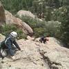 Scrambling down the east side descent off Mosaic Rock