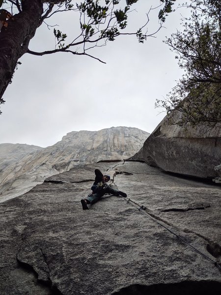 Ben climbing moby dick in the pouring rain.