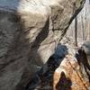 (A) 10-12ft boulder again, where you can see the degree of overhang and also some chalk from the starting hands of a sit start